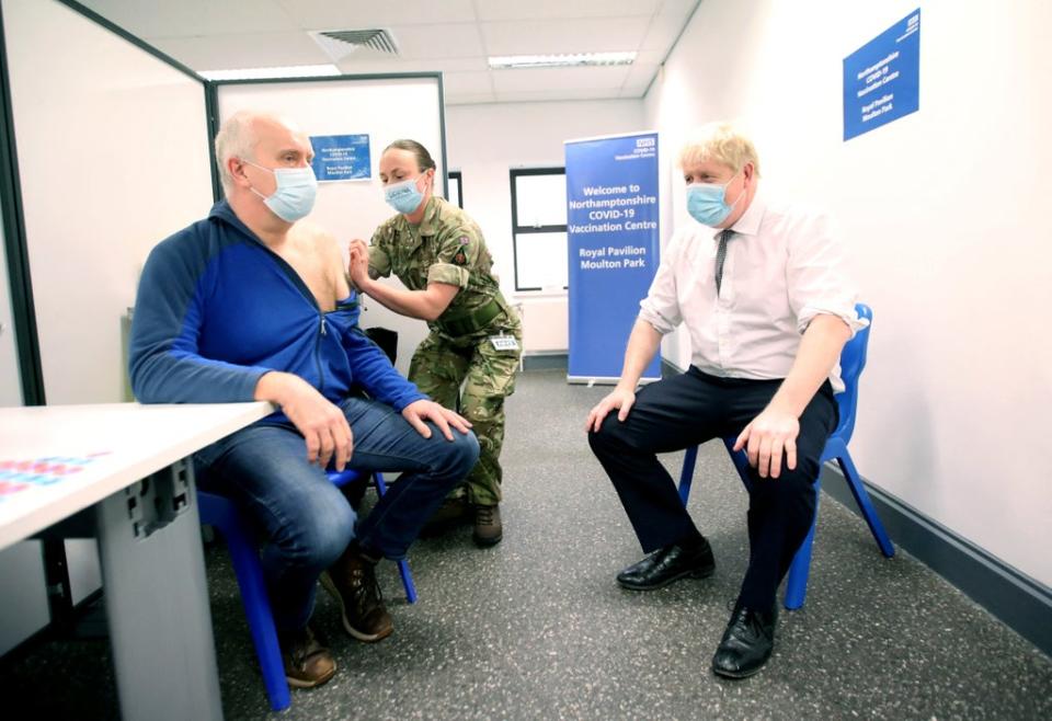 Prime Minister Boris Johnson watches as Gordon Halfacre receives a vaccination from Corporal Lorna MacDonald (Peter Cziborra/Reuters/Pool/PA) (PA Wire)