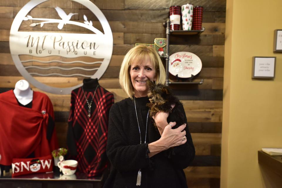 MI Passion owner Anita Varty holds her puppy inside her store in downtown Port Huron on Wednesday, Nov. 16, 2022.