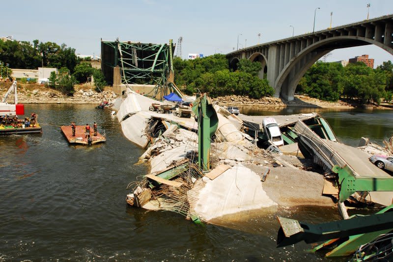 Navy divers from Mobile Diving and Salvage Unit 2 from the Naval Amphibious Base in Little Creek, Va., survey the wreckage of the I-35 Bridge in Minneapolis on August 7, 2007. The bridge collapsed August 1. File Photo by Joshua Adam Nuzzo/U.S. Navy