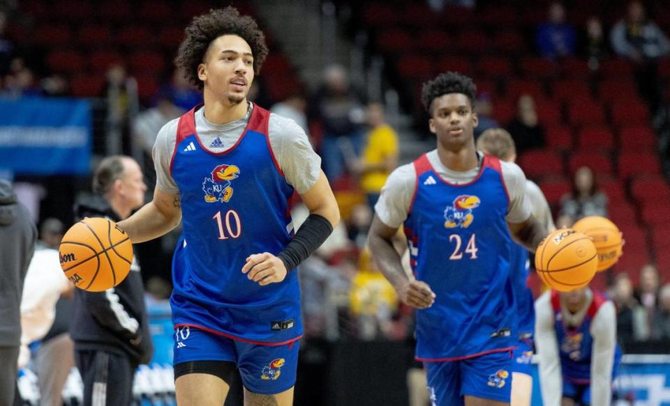 Kansas forwards Jalen Wilson (10) and K.J. Adams Jr. (24) dribble up the court during a team shoot around a day ahead of Kansas’ first round game against Howard in the NCAA college basketball tournament Wednesday, March 15, 2023, in Des Moines, Iowa.