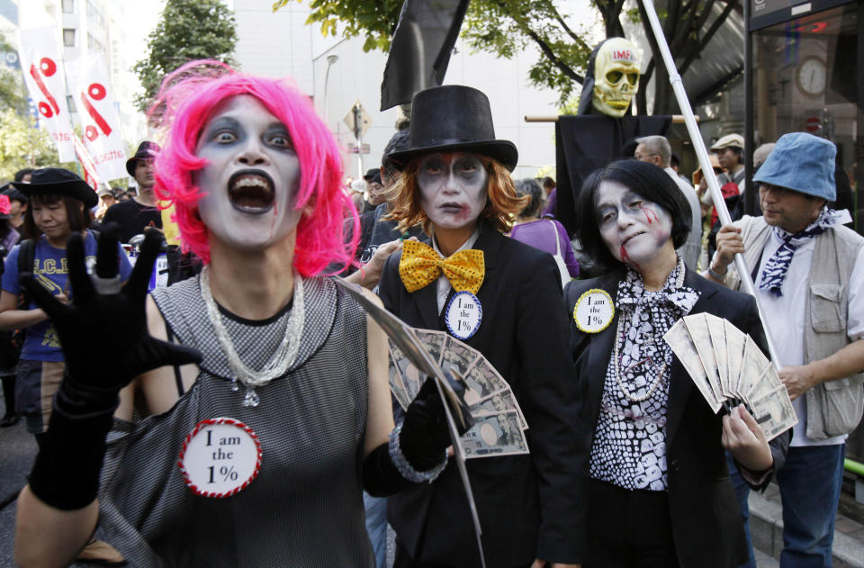 Participants march during a demonstration against the annual meetings of the IMF and World Bank being held in Tokyo, Saturday, Oct. 13, 2012. (AP Photo/Koji Sasahara)