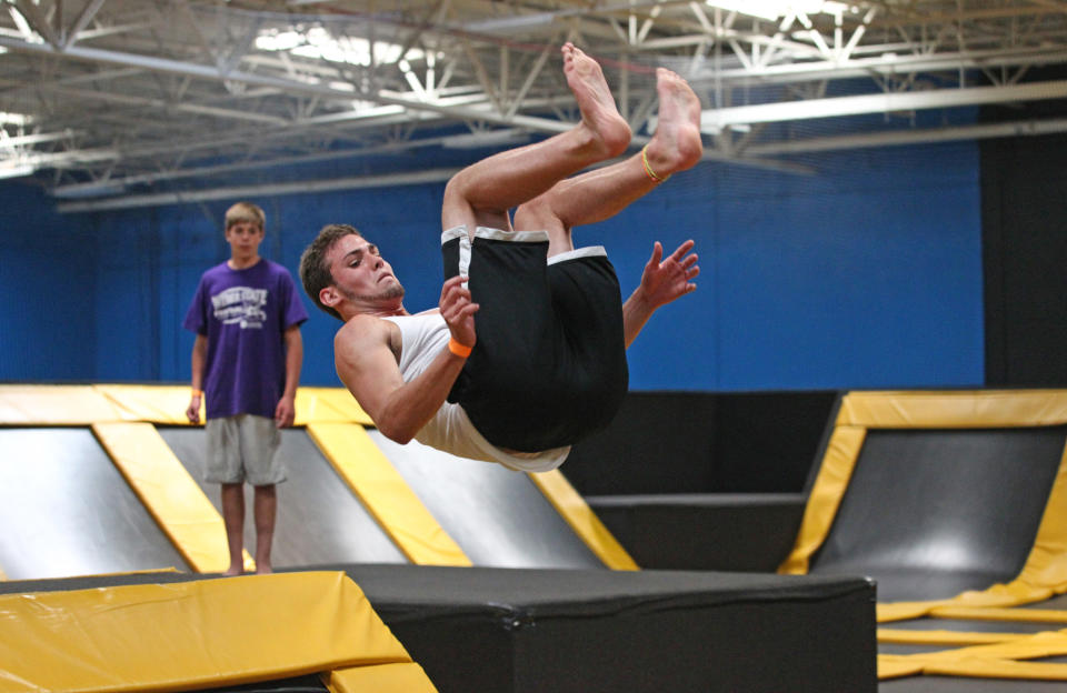 In this Wednesday, July 31, 2013, photo, Jacob Terrell of Pleasantville flips at the Get Air Hang Time indoor trampoline park in Orem, Utah. Indoor trampoline parks have cropped up around the country in recent years, offering customers a chance to bounce, flip and jump in wall-to-wall trampolines. The jump gyms offer the kind of rain-or-shine suburban entertainment popular for birthday parties and summer camps. But some doctors and officials say the parks are dangerous and can cause serious injuries. (AP Photo/Rick Bowmer)