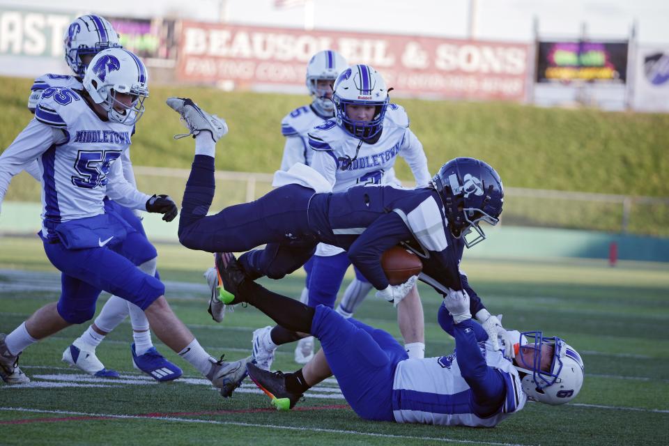 Middletown pulls down a Moses Brown ballhandler in Saturday's Division III Super Bowl in Cranston.