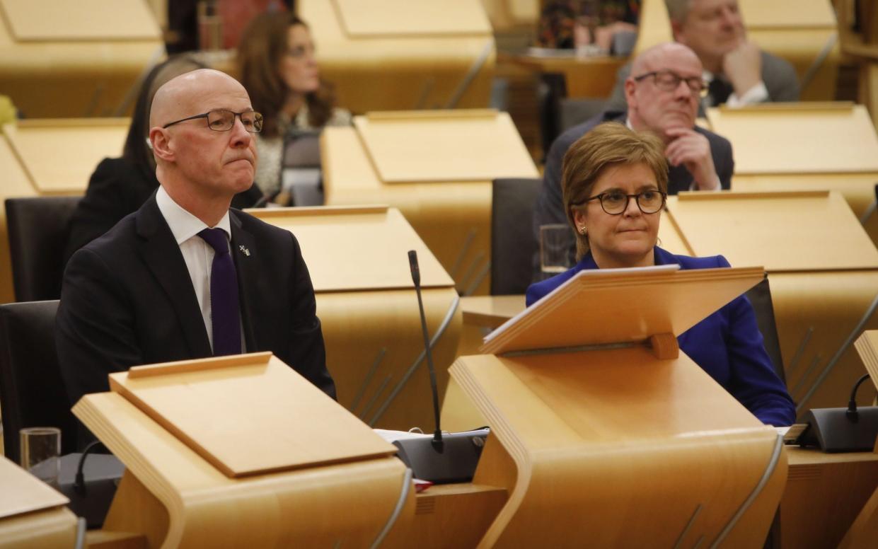 Nicola Sturgeon with John Swinney as he announced the higher rate in Scotland will rise from 41p to 42p from next April - Getty Images