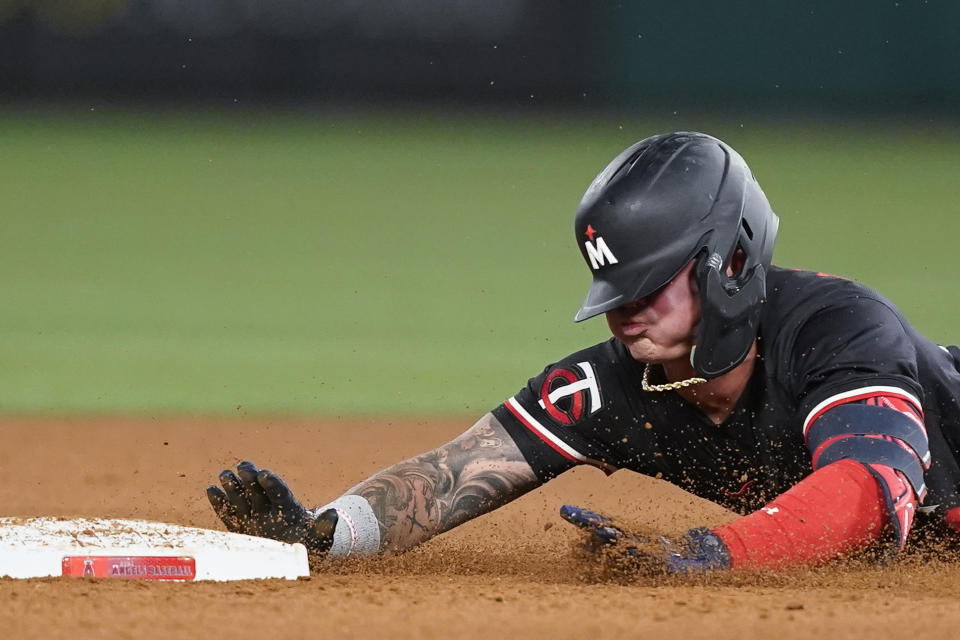 Minnesota Twins' Jose Miranda slides into second base after hitting a double during the sixth inning of a baseball game against the Los Angeles Angels, Friday, April 26, 2024, in Anaheim, Calif. (AP Photo/Ryan Sun)