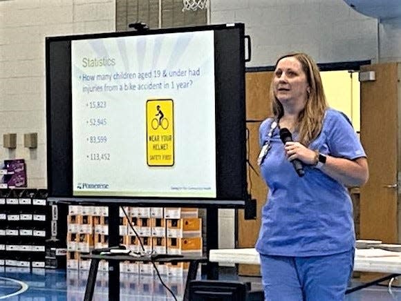 East Holmes School Board President and Pomerene Hospital Nurse Julia Klink spoke with fifth- through eight-grade Amish students about bike safety and head injuries during an assembly at Chestnut Ridge Elementary School.