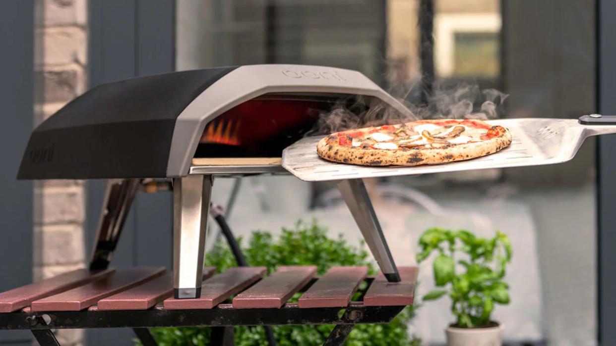  An Ooni Koda 12 pizza oven with a cooked pizza 