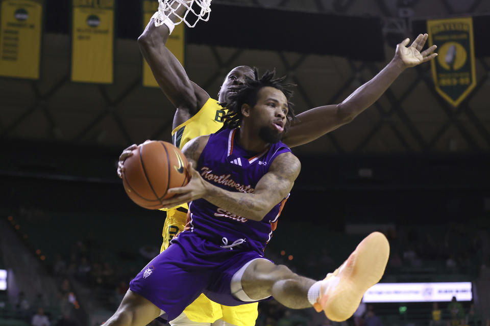 Northwestern State guard Braelon Bush looks to pass the ball as Baylor forward Jonathan Tchamwa Tchatchoua defends during the first half of an NCAA college basketball game Saturday, Dec. 2, 2023, in Waco, Texas. (AP Photo/Jerry Larson)