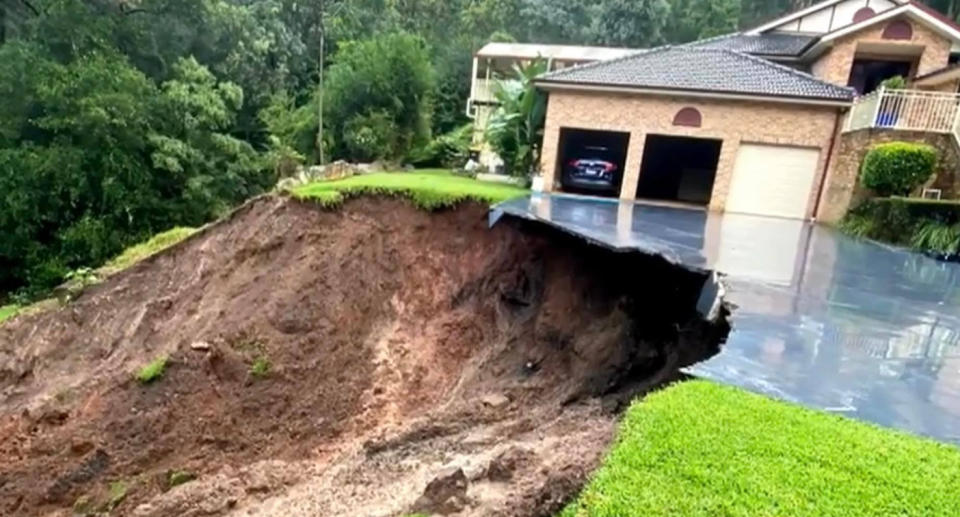 The Buksh family's home at Emu Heights teetering on the edge of the landslide.  