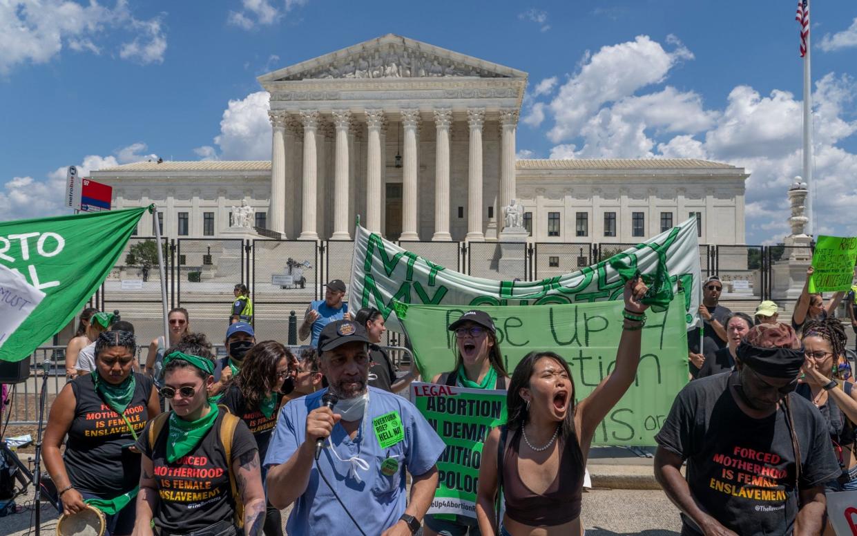 Protesters demonstrate outside the US Supreme after its ruling to overturn Roe v Wade - AP