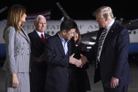 <p>President Donald Trump (R) shakes hands with U.S. detainee Tony Kim (C) as US Vice President Mike Pence (back L) and Melania Trump (L) look on, upon arrival after three detainees were freed by North Korea, at Joint Base Andrews in Maryland on May 10, 2018.(Photo by Saul Loeb/AFP/Getty Images) </p>