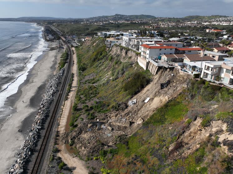 San Clemente, CA - March 16: Aerial view of four cliff-side, ocean-view apartment buildings that were evacuated and red tagged after heavy rains brought on a landslide that left the rear of the buildings in danger of tumbling down the cliff on Buena Vista in San Clemente Thursday, March 16, 2023. (Allen J. Schaben / Los Angeles Times)