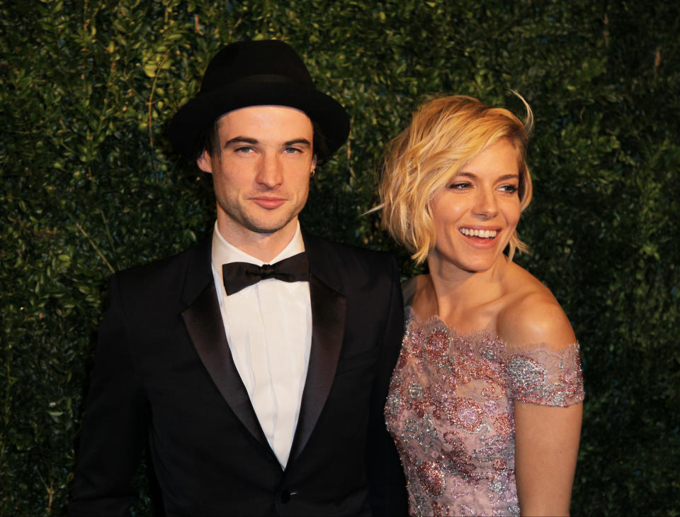 Actors Tom Sturridge and Sienna Miller pose for photographers on arrival at the Evening Standard Theatre Awards, on Sunday Nov 30, 2014 in Central London. (Photo by Grant Pollard/Invision/AP)