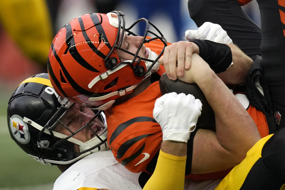 Pittsburgh Steelers linebacker T.J. Watt, bottom, sacks Cincinnati Bengals quarterback Jake Browning (6) during the second half of an NFL football game in Cincinnati, Sunday, Nov. 26, 2023. The Steelers won 16-10. (AP Photo/Carolyn Kaster)