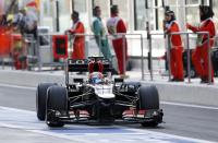 Lotus F1 Formula One driver Romain Grosjean of France drives in the pit lane during the third practice session of the Abu Dhabi F1 Grand Prix at the Yas Marina circuit on Yas Island, November 2, 2013. REUTERS/Ahmed Jadallah (UNITED ARAB EMIRATES - Tags: SPORT MOTORSPORT F1)