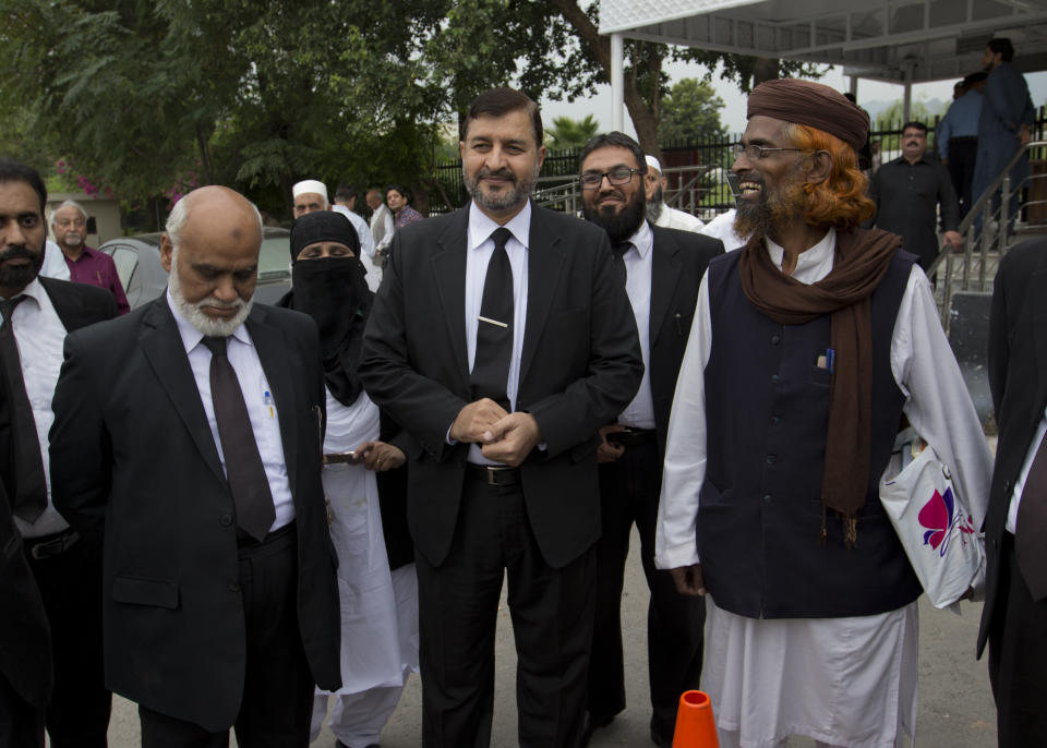 Pakistani lawyers who are contesting the case against Asia Bibi, a Pakistani Christian woman convicted of blasphemy, leave the Supreme court building in Islamabad, Pakistan, Monday, Oct. 8, 2018. Pakistan's Supreme Court has postponed its ruling on the final appeal of Bibi who has been on death row since 2010 after being convicted of blasphemy against Islam. Bibi's case has generated international outrage, but within Pakistan it has fired up radical Islamists, who use the blasphemy law to rally supporters and intimidate mainstream political parties. (AP Photo/B.K. Bangash)