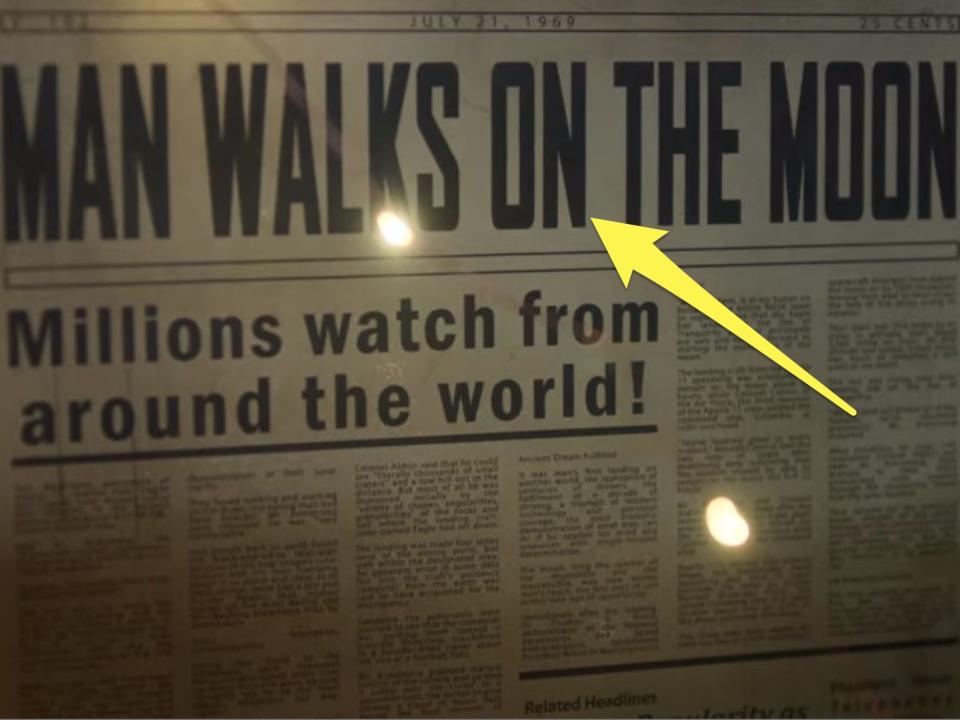 arrow pointing at headline on a newspaper about man walking on the moon in falling for christmas