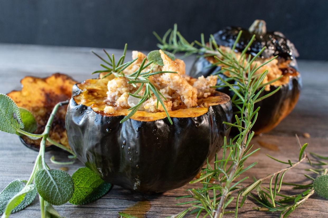 Baked acorn squash bowl with stuffing with rosemary and sage rustic