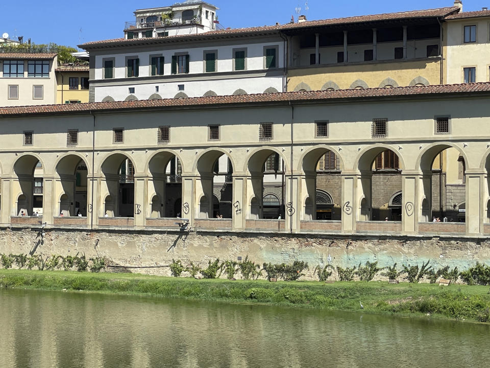 In this picture provided by the Uffizi Galleries on Wednesday, Aug. 23, 2023, spraypainted graffiti mark seven pilasters of the 'Corridoio Vasariano' in Florence, central Italy. The director of Florence's Uffizi Galleries, Eike Schmidt called Wednesday for U.S.-style penalties against vandals who spraypainted graffiti on exterior columns of the Varsari corridor connecting the famed museum to the Boboli Gardens.(Gallerie degli Uffizi via AP)