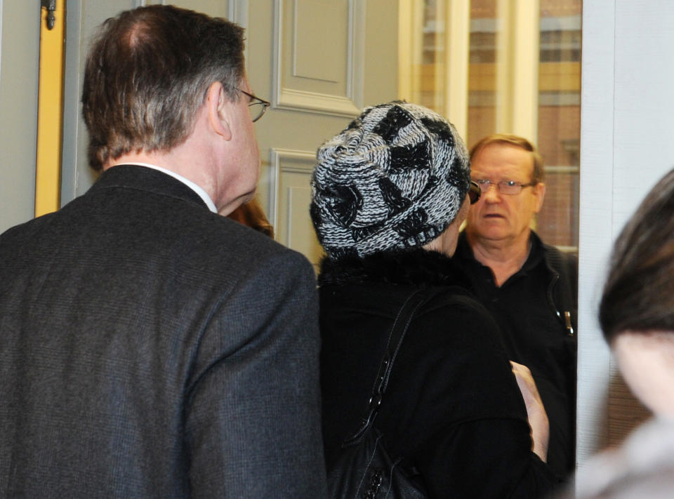 A 56-year-old anesthesiologist, center enters a Hamburg courtroom Tuesday Feb. 5, 2013. The anesthesiologist has been convicted of involuntary manslaughter in the death of a German porn star after a breast-enlargement operation. The dpa news agency reported Tuesday that the Hamburg hospital doctor, identified only by the initials M.F. to protect her identity according to German law, was given a 15-month suspended sentence. She was found guilty by the Hamburg state court of not ensuring that 23-year-old Carolin Wosnitza, who went by the stage name "Sexy Cora" had enough oxygen during the 2011 cosmetic surgery. (AP Photo/dpa, Angelika Warmuth/