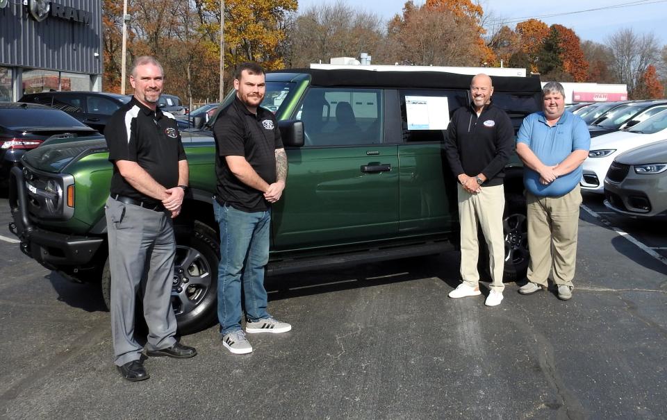 Jeff Drennen, second from right, with members of sales team Josh Ward, Adam Mills and Jay Shepler with a Ford Bronco. Drennen has two lots in Coshocton. The one one Second Street is a Ford dealer and the Otsego lot has Chrysler, Dodge, Jeep and Ram vehicles.