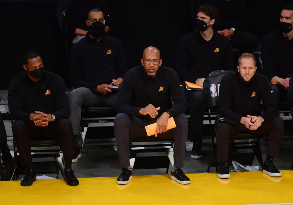 May 30, 2021; Los Angeles, California, USA; Phoenix Suns head coach Monty Williams (center), along with assistants Willie Green (left) and Kevin Young (right), watches game action against the Los Angeles Lakers during the first half in game four of the first round of the 2021 NBA Playoffs. at Staples Center.