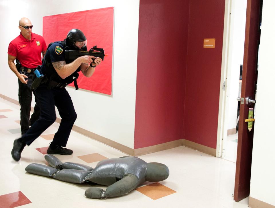 Palm Beach Police Sgt. Scott Duquette and officer Taylor Molinaro train to respond alone to an active shooter call at Palm Beach Public in July 2018.