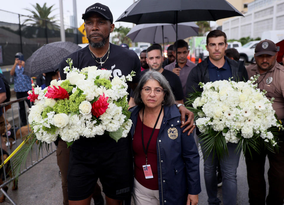 Image: Udonis Haslem of the Miami Heat and Miami-Dade County Mayor Daniella Levine Cava arrive at a memorial after the Champlain Towers South building collapse on June 30, 2021 in Surfside, Fla. (Joe Raedle / Getty Images file)