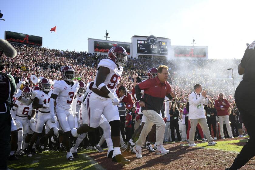 Alabama coach Nick Saban leads the Crimson Tide onto the field before facing Michigan in the Rose Bowl