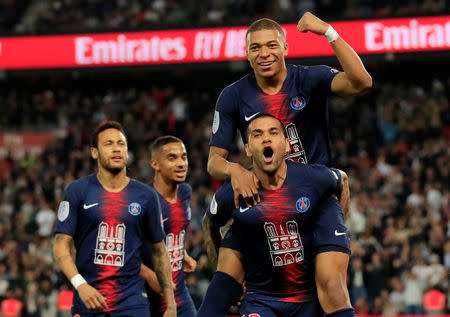 Soccer Football - Ligue 1 - Paris St Germain v AS Monaco - Parc des Princes, Paris, France - April 21, 2019 Paris St Germain's Kylian Mbappe celebrates scoring their third goal and completing his hat-trick with Dani Alves REUTERS/Gonzalo Fuentes