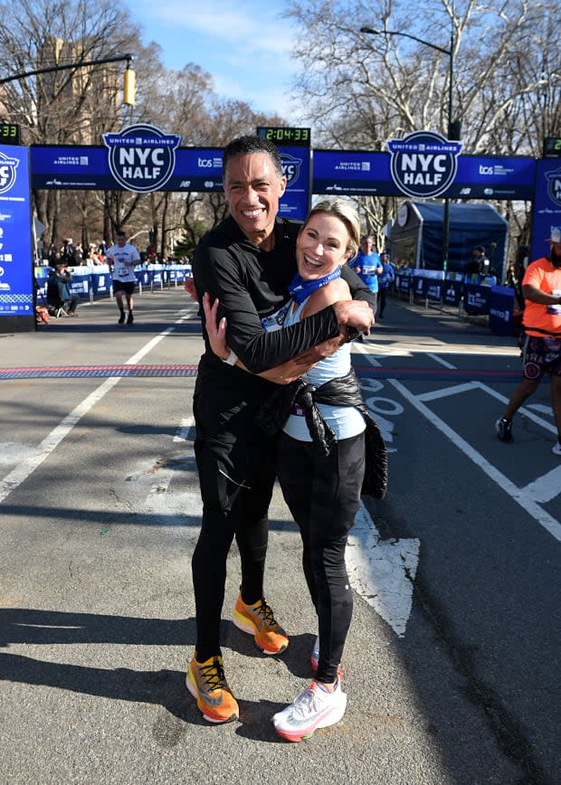 <em>T.J. Holmes and Amy Robach of 'Good Morning America' celebrate as they cross the finish line during the 2022 United Airlines NYC Half Marathon on March 20, 2022 in New York City.</em><p>Bryan Bedder/New York Road Runners via Getty Images</p>