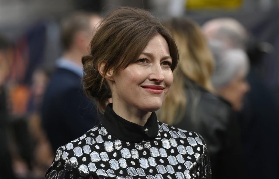 kelly macdonald smiles as she appears at a red carpet event