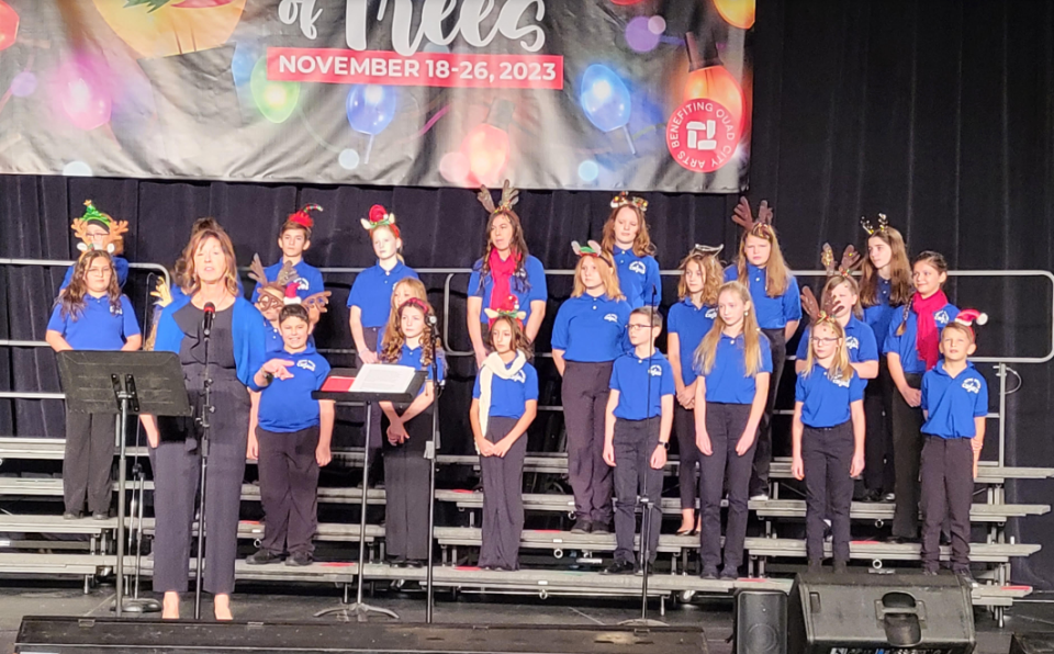 Valeree Pieper, left, with the Music Guild Youth Chorus at last November’s Festival of Trees at the RiverCenter.