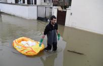 <p>A man walks in a flooded street on Jan. 30, 2018, in Villeneuve-le-Roi, near Paris. (Photo: Alain Jocard/AFP/Getty Images) </p>