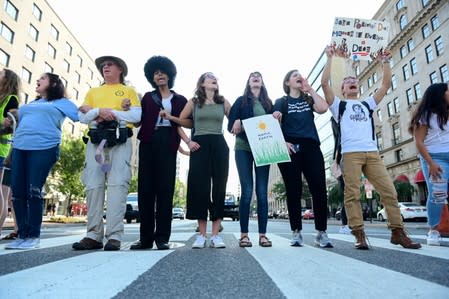 Climate change activists block traffic at an intersection near the White House in Washington