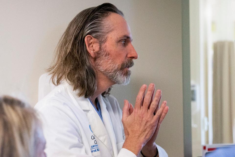 Dr. Derek Kelly, an orthopedic surgeon at Le Bonheur Children’s Hospital and Campbell Clinic, looks over patient records at the hospital in Memphis, Tenn., on Wednesday, November 29, 2023. As of Dec. 6, Le Bonheur had treated a record 165 gunshot victims in 2023 – and these numbers don’t include the youth who are treated elsewhere or pronounced dead on the scene.