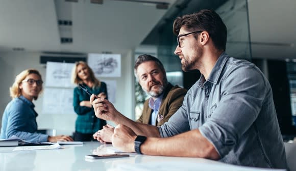 People seated around a table in an office