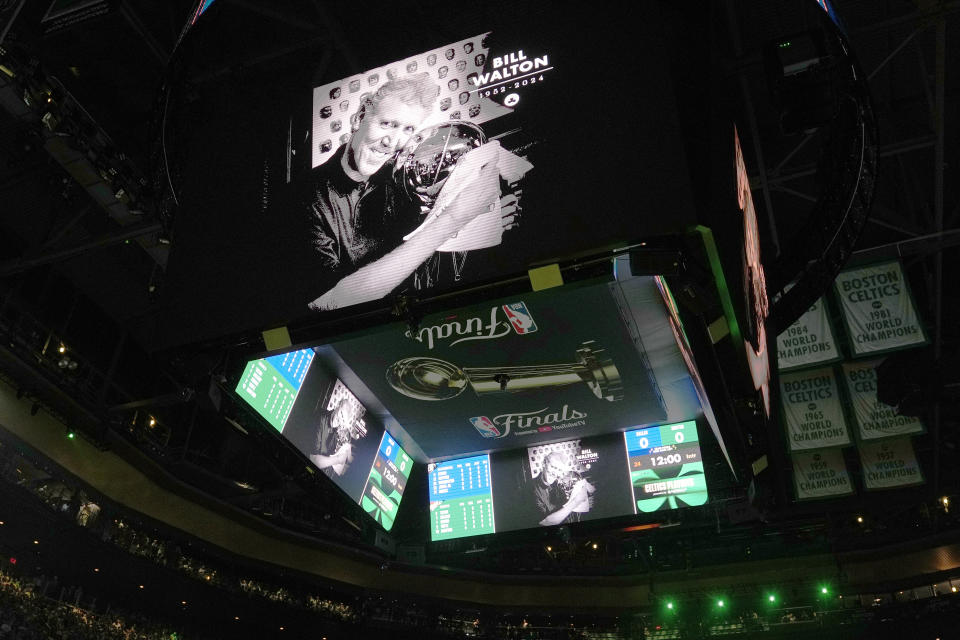 A display honoring basketball great Bill Walton appears on a screen before Game 1 of basketball's NBA Finals between the Boston Celtics and the Dallas Mavericks, Thursday, June 6, 2024, in Boston. (AP Photo/Charles Krupa)