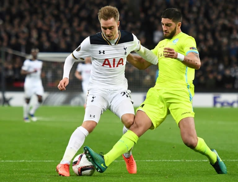 Tottenham Hotspur's Danish midfielder Christian Eriksen (L) is tackled by Gent's French defender Samuel Gigot (R) during the UEFA Europa League Round of 32 second-leg football match between Tottenham Hotspur and KAA Gent on February 23, 2017