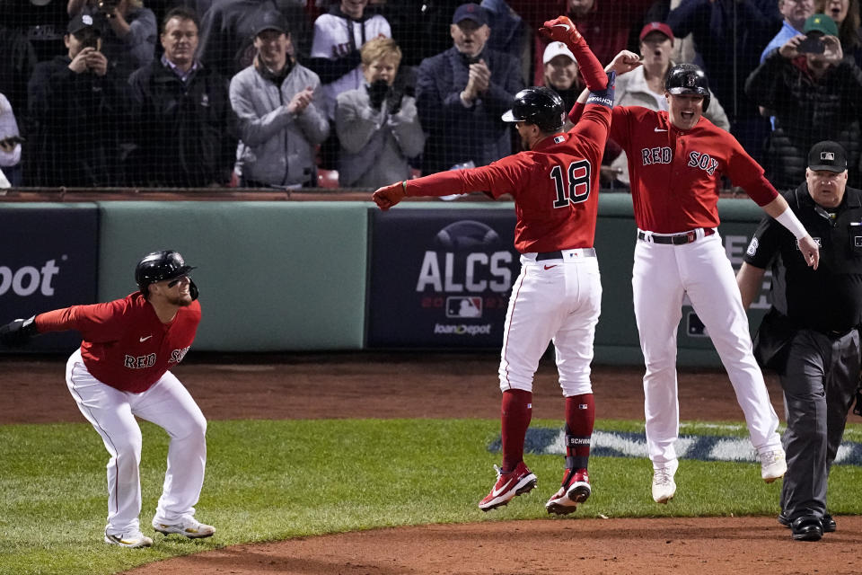 Boston Red Sox's Kyle Schwarber (18) celebrates a grand slam home run against the Houston Astros during the second inning in Game 3 of baseball's American League Championship Series Monday, Oct. 18, 2021, in Boston. (AP Photo/Robert F. Bukaty)