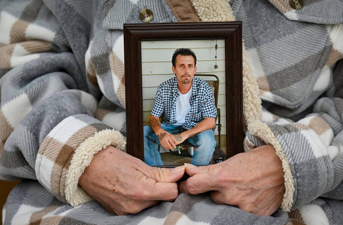Linda Elder of Kansas City clasps a photograph of her beloved son, Brandon Elder, 38, who died last November of fentanyl intoxication.