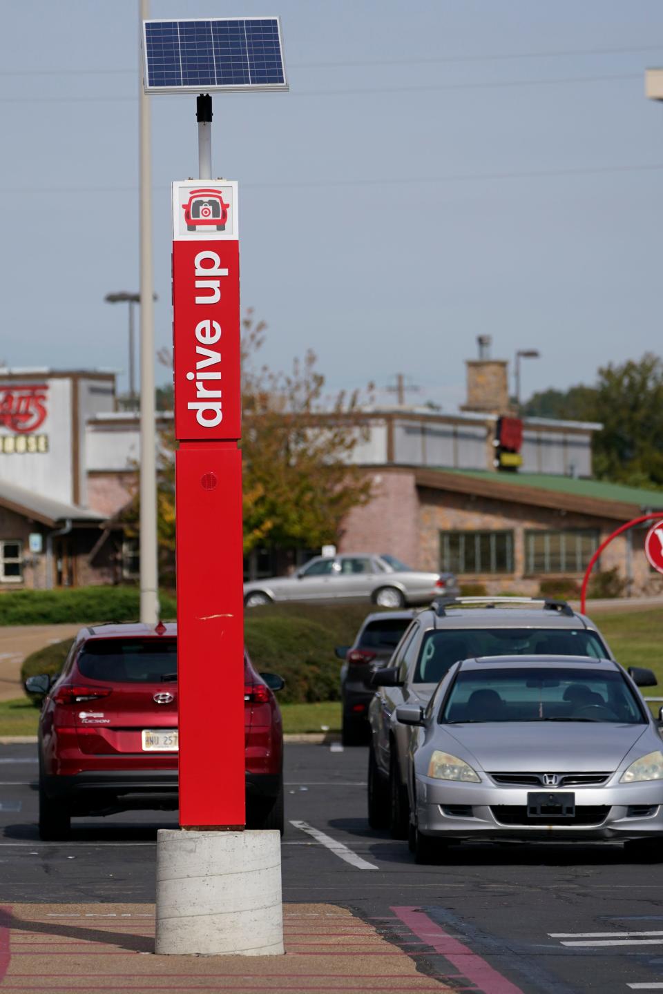 A sign designating a drive up parking lot for curbside pickup stands out against the backdrop of the Target logo outside this northeast Jackson store on Thursday, Nov. 5, 2020.