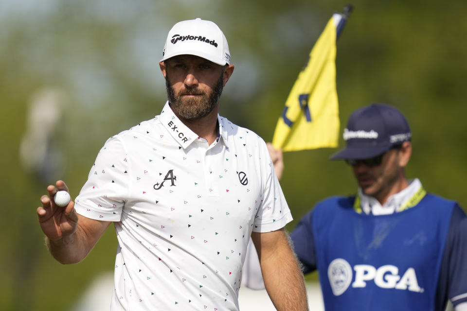 Dustin Johnson waves after his putt on the fifth hole during the first round of the PGA Championship golf tournament at Oak Hill Country Club on Thursday, May 18, 2023, in Pittsford, N.Y. (AP Photo/Seth Wenig)