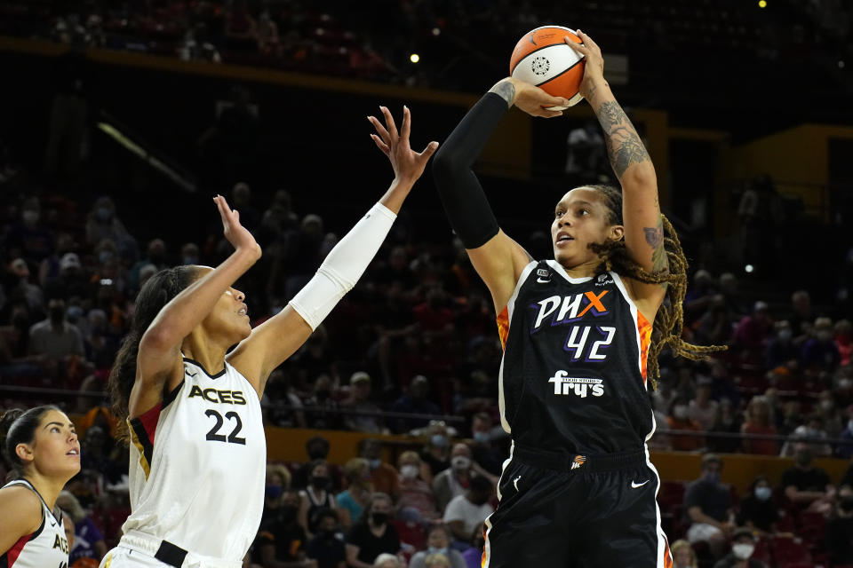 Phoenix Mercury center Brittney Griner (42) shoots over Las Vegas Aces forward A'ja Wilson (22) during the first half of a WNBA basketball game Sunday, Oct. 3, 2021, in Phoenix. (AP Photo/Rick Scuteri)