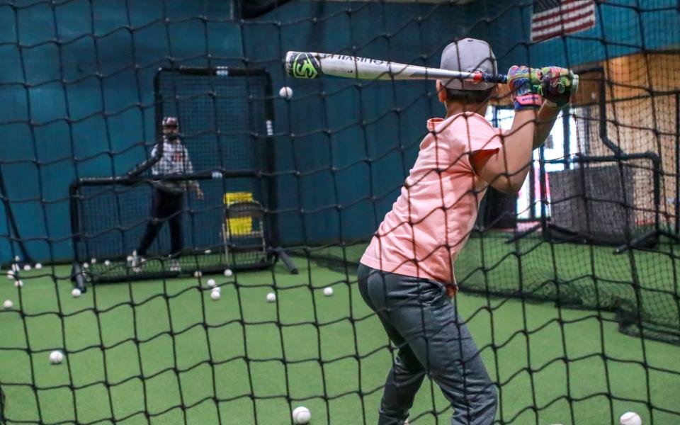 Paul St. Germain loads as he awaits the pitch from his hitting instructor Sean Riley at Inside The Park Batting Cages in New Bedford.