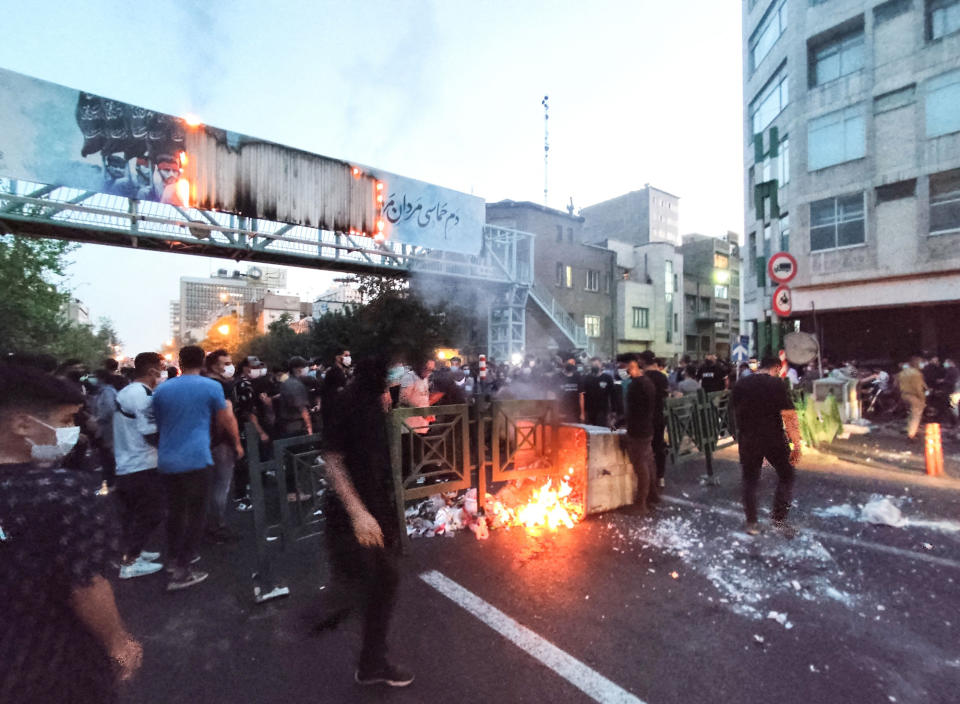 <p>Demonstrators burn a trash can in Tehran on Sept. 21. </p>