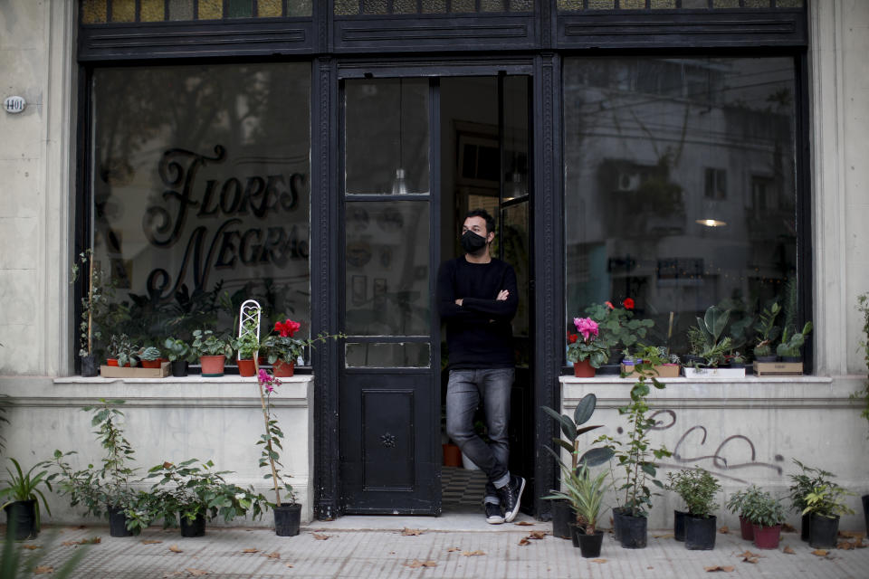 Tango dancer and musician Nicolas Ponce poses for a portrait outside the plant shop he started up after the COVID-19 pandemic lockdown closed dance venues in Buenos Aires, Argentina, Friday, June 4, 2021. Although it's a symbol of Argentine culture, tango does not get any specific subsidies. (AP Photo/Natacha Pisarenko)