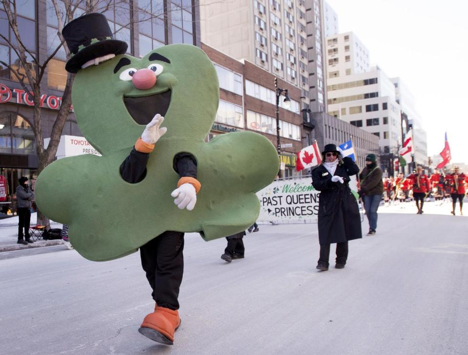 A giant shamrock waves to spectators during the annual St. Patrick's Day parade in Montreal, Sunday, March 16, 2014. (AP Photo/The Canadian Press, Graham Hughes)