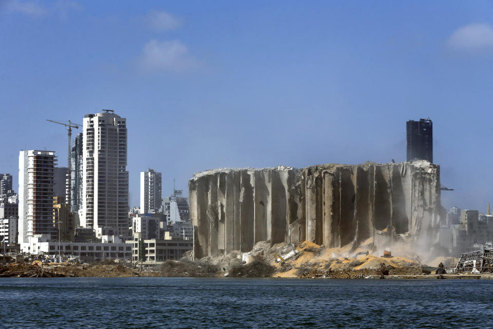 Earth moving equipment and rescue workers search for victims at the site of the Aug. 4 explosion that hit the seaport of Beirut, Lebanon, Saturday, Aug. 15, 2020. (AP Photo/Bilal Hussein)