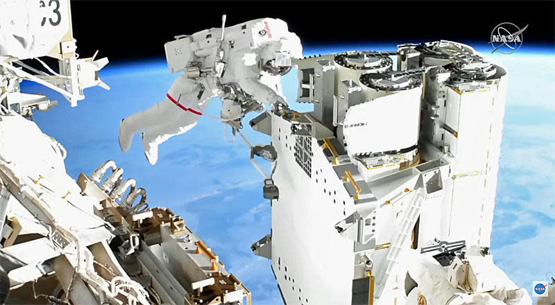 French astronaut Thomas Pesquet works to unbolt a set of roll-out solar arrays so they could be moved to the far left end of the International Space Station's power truss for installation.  / Credit: NASA TV